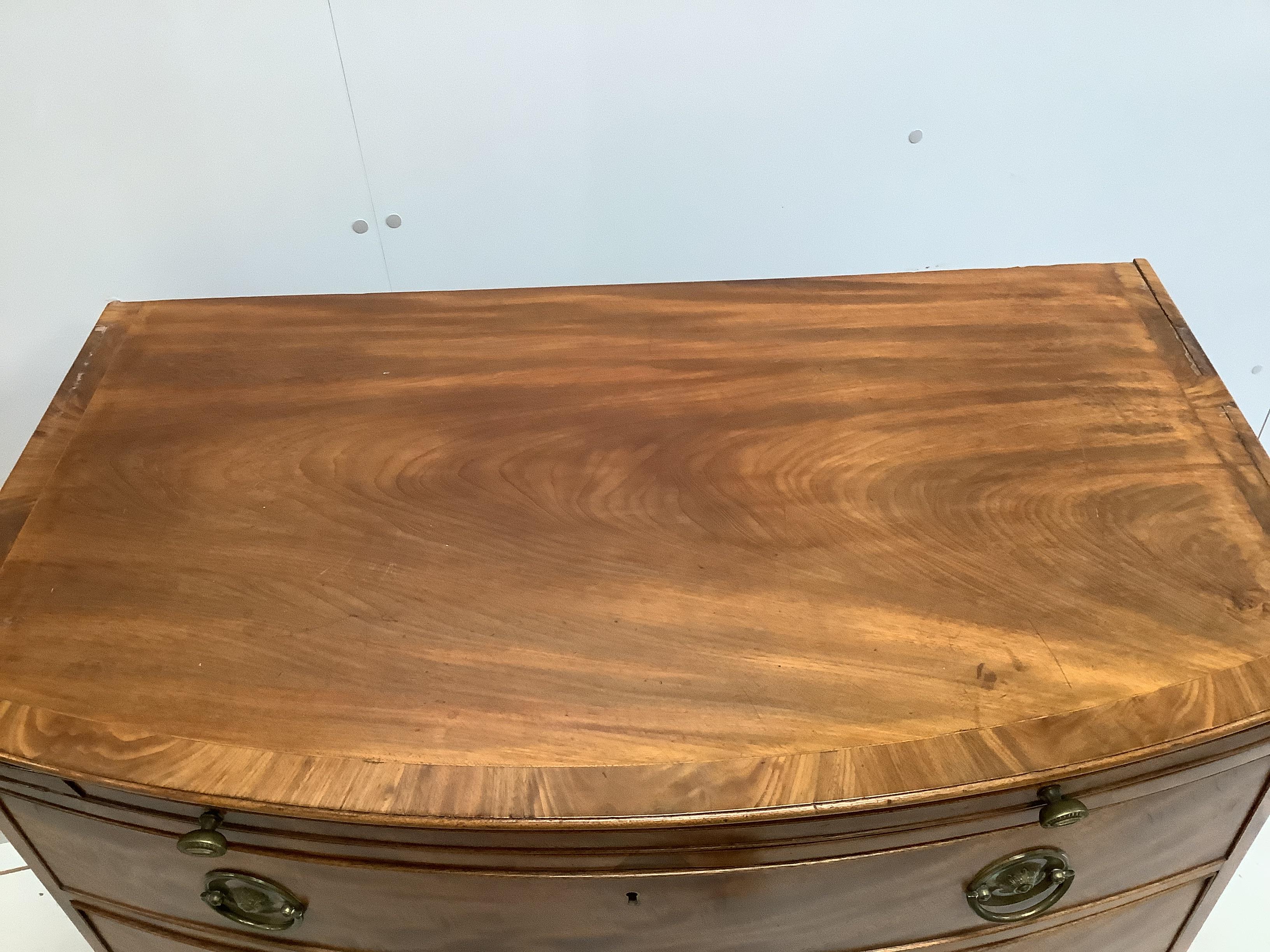 A Regency mahogany bow front chest of three drawers, fitted slide, width 98cm, depth 59cm, height 87cm